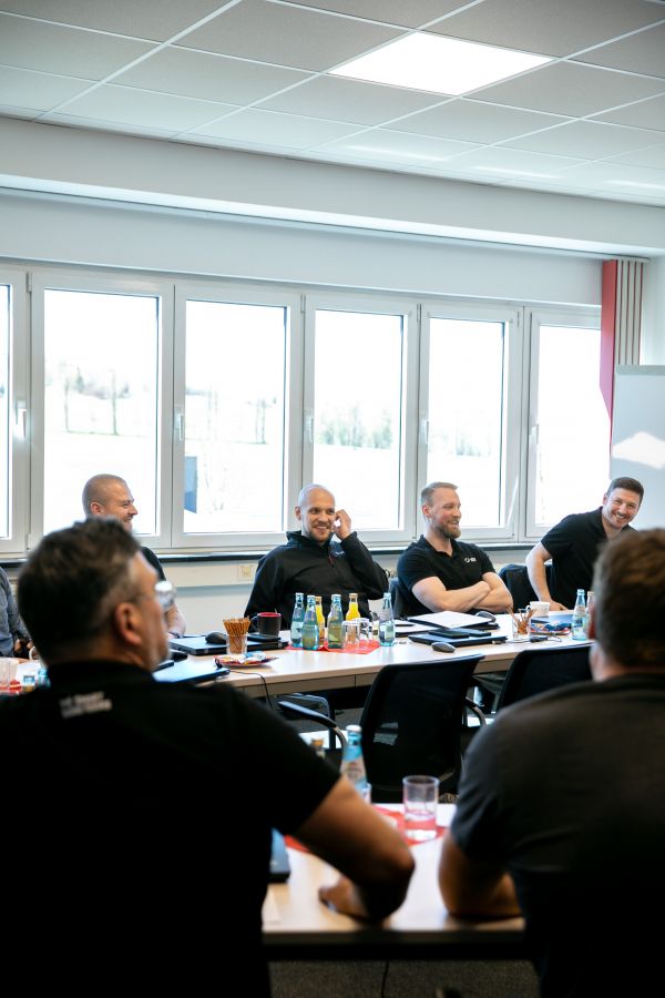 Participants of the IDT–Steffca workshop seated at conference tables in a bright meeting room