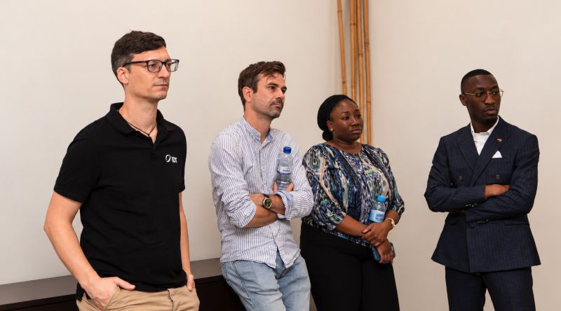 IDT team member with three business contacts during the delegation visit to Mozambique